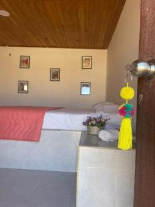 a bedroom with a bed and a table with flowers at Hotel Cabo Royal in Cabo de la Vela