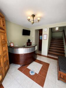 a lobby with a reception desk and a staircase at Hotel Bartolomé in Oaxaca City