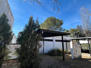 a pavilion with a sign in front of a building at Las Artes Lodge in Mina Clavero