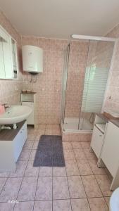 a bathroom with a shower and a sink and a toilet at Studios Dolček in Krvavica