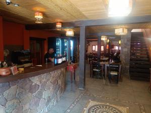 a bar in a restaurant with a man sitting at it at Cielo Andino Colonial in Purmamarca
