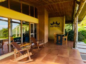 a patio with chairs and a table in a building at Peaceful Mountain Experience - Coyote House in Poás