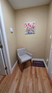 a room with a chair and a painting on the wall at Small Town Bound Inn in Vernon River +19 photos