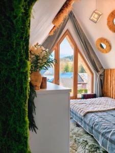 a bedroom with a bed and a large window at Lux Houses w DOMKU tylko DWA APARTAMENTYz jacuzzi zewnętrznym in Groń