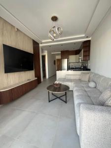 a living room with a couch and a table at Appartement mirador golf 3 in Cabo Negro