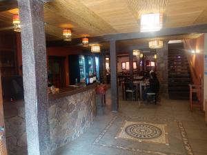 a bar in a restaurant with a person sitting at a table at Cielo Andino Colonial in Purmamarca +18 photos