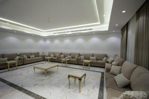 a lobby with couches and tables in a room at فيلا ابو بندر in Jeddah