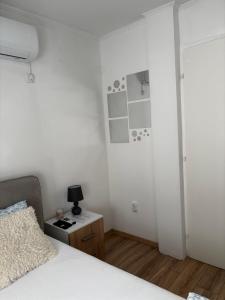 a bedroom with a bed and a table with a lamp at Studio Apartman M&S Apatin in Apatin