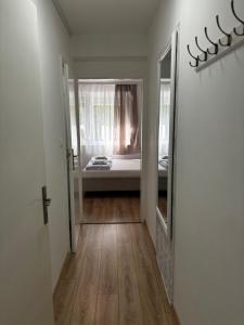 a hallway with a room with a bed and a mirror at Studio Apartman M&S Apatin in Apatin