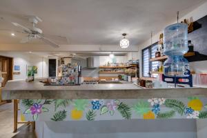 a kitchen with a counter with pineapple painted on it at Hotel Café Con Leche in Playa Santana