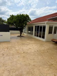 a building with a tree in the middle of a yard at Refúgio D'Aldeia in Leiria