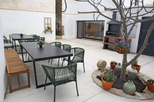 a patio with tables and chairs and a tree at Casa Rural Garcés in Lumbier
