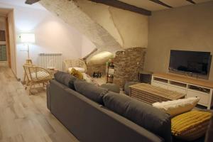 a living room with a couch and a tv at Casa Rural Garcés in Lumbier