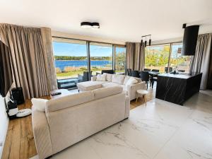 a living room with a couch and a table at Zegrze Riva with the view in Zegrze Południowe