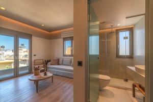 a bathroom with a shower and a toilet and a couch at Minotaur's Rest - Luxury Residences with Free Private Parking, near Port & Airport in Heraklio +139 photos