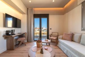 a living room with a couch and a table at Minotaur's Rest - Luxury Residences with Free Private Parking, near Port & Airport in Heraklio