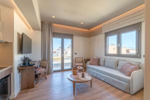 a living room with a couch and a tv at Minotaur's Rest - Luxury Residences with Free Private Parking, near Port & Airport in Heraklio