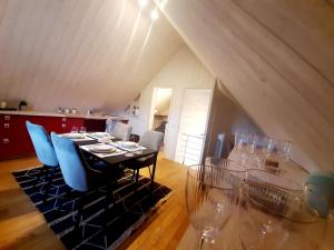 a dining room with a table with chairs and wine glasses at Nature Circuit Francorchamps in Stavelot +8 photos