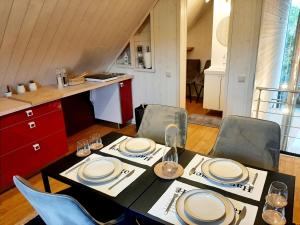a table with plates and glasses on it in a kitchen at Nature Circuit Francorchamps in Stavelot
