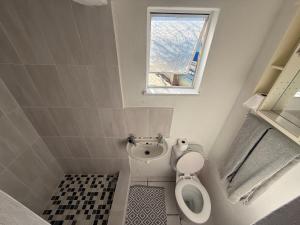 a small bathroom with a toilet and a window at Suite Dreams Cute Studio Flat in Panorama