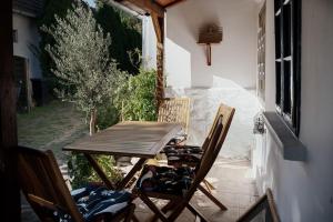 a wooden table and chairs on a patio at Thermal Corner Guesthouse in Alsópáhok