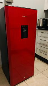 a red refrigerator in a kitchen with its door open at DL Apartments in Palatswe