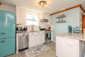 a kitchen with white cabinets and a blue refrigerator at Blue Chill in Hampton