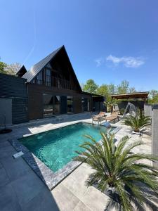 a swimming pool in front of a house at Sapanca Ruby Bungalow in Sapanca