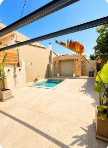 a patio with a swimming pool in a house at Porto Minimal Oasis in Porto Rafti