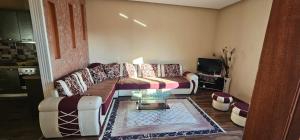 a living room with a couch and a table at Villa Doda in Durrës +5 photos