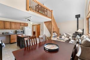 a kitchen and a living room with a table and a couch at Sugarbush Seclusion in Vermont in Waitsfield +6 photos