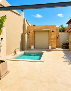 a swimming pool in the backyard of a house at Porto Minimal Oasis in Porto Rafti