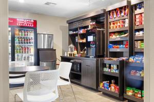a coffee shop with a table and chairs and drinks at Candlewood Suites Killeen - Fort Hood Area by IHG in Killeen