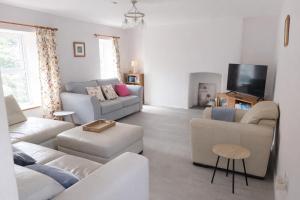 a living room with two couches and a tv at Swallows Rest Cottage - 3 Bedrooms - Nr Looe in Looe