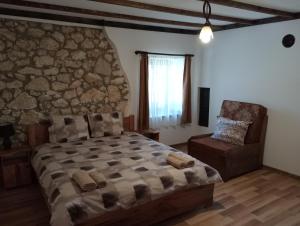 a bedroom with a large bed and a chair at Мехса in Svetoslav +27 photos