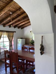 a kitchen and dining room with a table and chairs at El Caserío Jujuy in Volcán