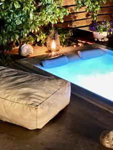 a swimming pool with a large ottoman in a backyard at Averto House Lefkada in Lefkada
