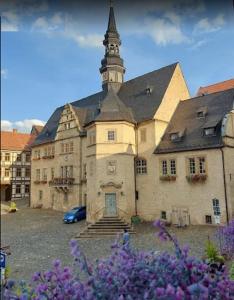 a large building with a tower on top of it at Große Wohnung in dritter Etage mit Terrasse im Altstadtzentrum - Ferienwohnung Chiplakoff in Blankenburg