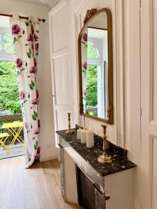 a bathroom with a vanity with a mirror and a sink at Les Meublés d'Etigny in Luchon +51 photos
