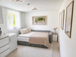a small bedroom with a bed and a sink at D&C Norway in Kristiansand