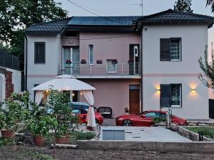 a red car parked in front of a house at Holiday Home Varese- Family & Group stay with private parking in Varese