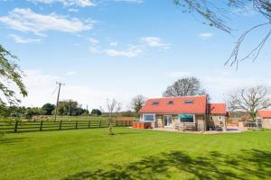 a house with an orange roof in a field at 3 Bed in Ebberston oc-s35053 in Ebberston