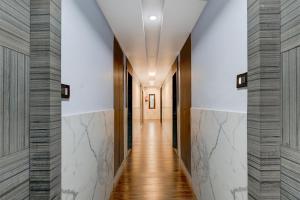 a hallway with white walls and wood floors at Super Townhouse V Hotel in Gunadala