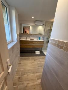 a bathroom with a sink and a toilet and a mirror at La Clef des Champs in Mecquignies +21 photos
