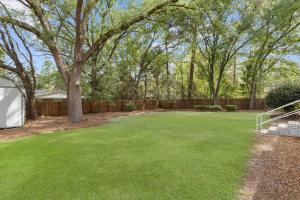a yard with green grass and a fence at GSU Getaway 4BR3BA spacious pet friendly in Statesboro