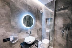 a bathroom with a sink and a shower at Day Lux Superior Apartments in Sarandë +85 photos