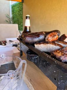 a table with some food and a bottle of beer at Refugio Andino in Tupungato