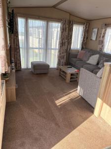a living room with a couch and a table at Sunrise in Selsey