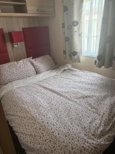 a bedroom with a bed and a window at Sunrise in Selsey