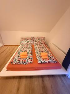 a bed with two pillows on it in a room at GalerieLoft Winterzeit Thunersee&Mountainview in Thun
